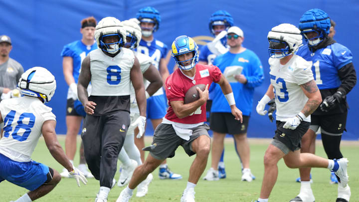 Jun 3, 2025; Woodland Hills, CA, USA; Los Angeles Rams quarterback Jimmy Garoppolo (11) carries the ball during organized team activities at Rams Practice Facility. Mandatory Credit: Kirby Lee-Imagn Images Jun 3, 2025; Woodland Hills, CA, USA; Los Angeles Rams quarterback Jimmy Garoppolo (11) carries the ball during organized team activities at Rams Practice Facility. Mandatory Credit: Kirby Lee-Imagn Images