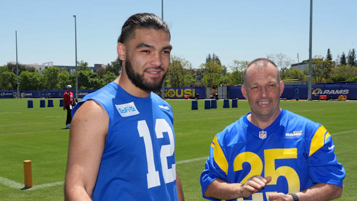 May 7, 2025; Woodland Hills, CA, USA; Los Angeles Rams receiver Puka Nacua (left) talks with Hawaii governor Josh Green, M.D. after a press conference at the Rams Practice Facility to announce a partnership between the Rams and the Hawaii Tourism Authority to hold minicamp in Maui. Mandatory Credit: Kirby Lee-Imagn Images May 7, 2025; Woodland Hills, CA, USA; Los Angeles Rams receiver Puka Nacua (left) talks with Hawaii governor Josh Green, M.D. after a press conference at the Rams Practice Facility to announce a partnership between the Rams and the Hawaii Tourism Authority to hold minicamp in Maui. Mandatory Credit: Kirby Lee-Imagn Images