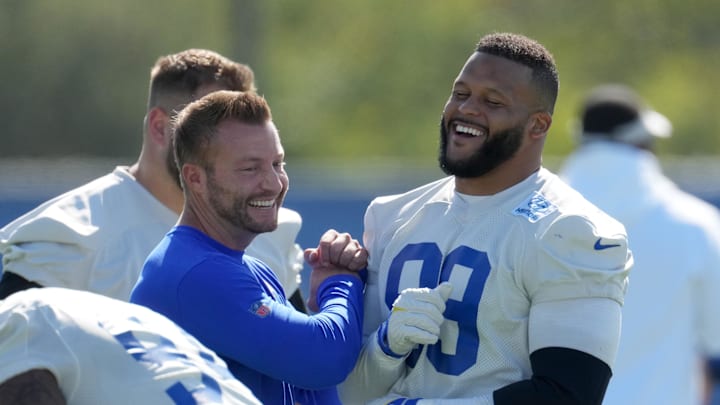 Jun 7, 2022; Thousand Oaks, California, USA; Los Angeles Rams defensive end Aaron Donald (99) and coach Sean McVay react during minicamp at Cal Lutheran University. Mandatory Credit: Kirby Lee-Imagn Images