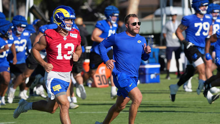 Jul 23, 2025; Los Angeles, CA, USA; Los Angeles Rams coach Sean McVay runs with quarterback Stetson Bennett (13) during training camp at Loyola Marymount University. Mandatory Credit: Kirby Lee-Imagn Images