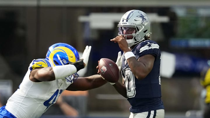Aug 9, 2025; Inglewood, California, USA; Dallas Cowboys quarterback Joe Milton III (10) is sacked by Los Angeles Rams linebacker Josaiah Stewart (41) in the first half at SoFi Stadium. Mandatory Credit: Kirby Lee-Imagn Images