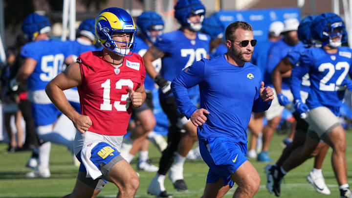 Jul 23, 2025; Los Angeles, CA, USA; Los Angeles Rams coach Sean McVay runs with quarterback Stetson Bennett (13) during training camp at Loyola Marymount University. Mandatory Credit: Kirby Lee-Imagn Images