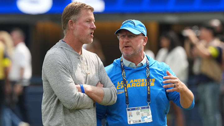 Aug 16, 2025; Inglewood, California, USA; Los Angeles Rams general manager Les Snead (left) talks with Los Angeles Chargers general manager Joe Hortiz at SoFi Stadium. Mandatory Credit: Kirby Lee-Imagn Images