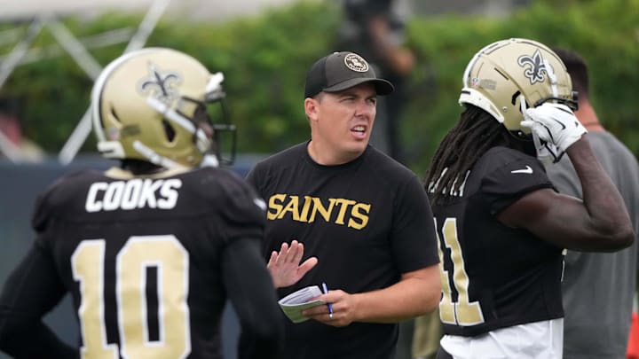 Aug 14, 2025; Carson, CA, USA; New Orleans Saints coach Kellen Moore (center) talks with wide receiver Brandin Cooks (10) and wide receiver Cedrick Wilson Jr. (11) during a joint practice against the Los Angeles Rams at the Dignity Health Sports Park. Mandatory Credit: Kirby Lee-Imagn Images