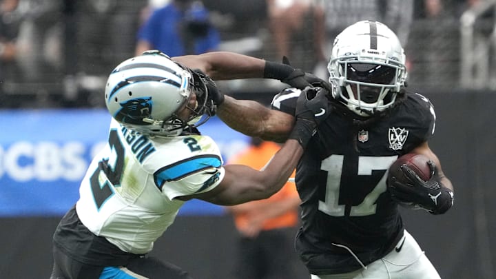 Adams carries the ball against Panthers cornerback Michael Jackson.