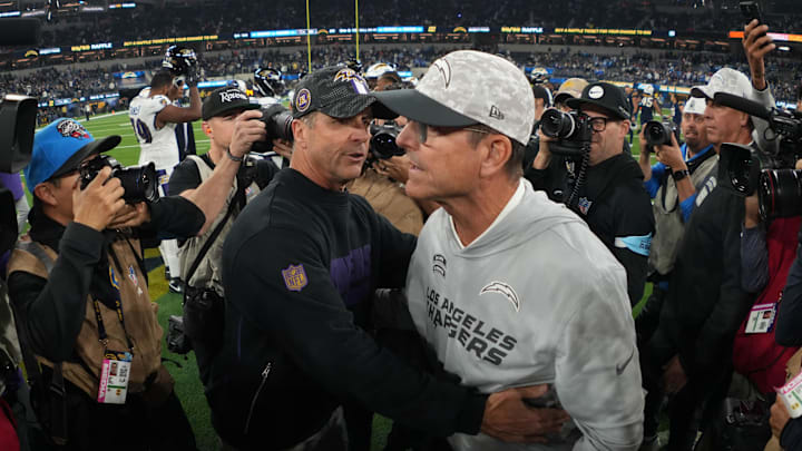 Baltimore Ravens coach John Harbaugh shakes hands with brother and Los Angeles Chargers coach Jim Harbaugh after the game at SoFi Stadium. 