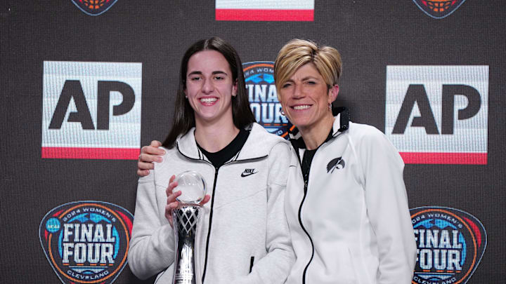Apr 4, 2024; Cleveland, OH, USA; Iowa Hawkeyes guard Caitlin Clark (left) poses with associate head coach Jan Jensen after being selected as the AP Player of the Year at a press conference at Rocket Mortgage FieldHouse. Mandatory Credit: Kirby Lee-Imagn Images