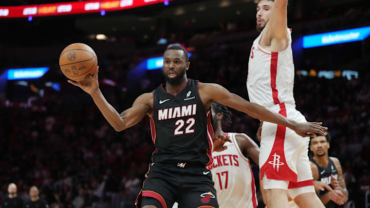 Mar 21, 2025; Miami, Florida, USA;  Miami Heat forward Andrew Wiggins (22) grabs a rebound as Houston Rockets center Alperen Sengun (28) looks on in the second half at Kaseya Center. Mandatory Credit: Jim Rassol-Imagn Images