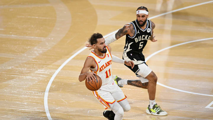 Dec 14, 2024; Las Vegas, Nevada, USA; Atlanta Hawks guard Trae Young (11) controls the ball against Milwaukee Bucks guard Gary Trent Jr. (5) during the fourth quarter in a semifinal of the 2024 Emirates NBA Cup at T-Mobile Arena. Mandatory Credit: Candice Ward-Imagn Images