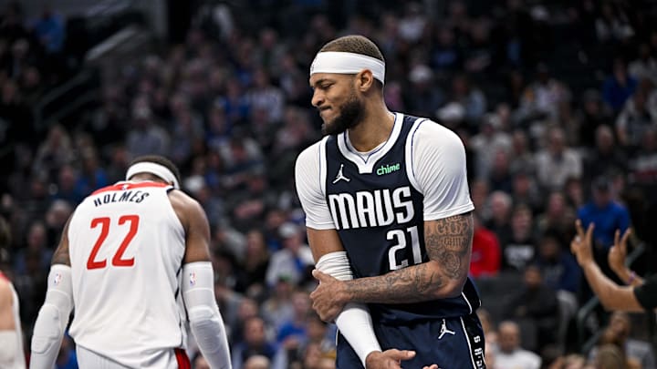 Feb 12, 2024; Dallas, Texas, USA; Dallas Mavericks center Daniel Gafford (21) grabs his elbow after he collides with Washington Wizards forward Richaun Holmes (22) during the second half at the American Airlines Center. Mandatory Credit: Jerome Miron-Imagn Images