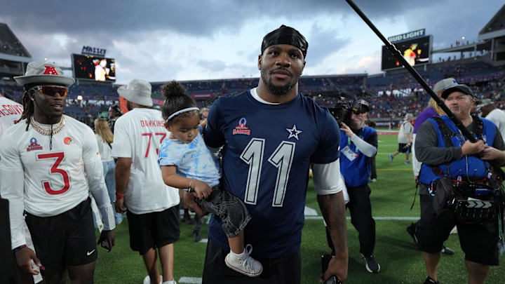 Feb 2, 2025; Orlando, FL, USA; NFC defensive end Micah Parson of the Dallas Cowboys (11) holds his daughter Shatara Parsons after the 2025 Pro Bowl Games at Camping World Stadium. Mandatory Credit: Kirby Lee-Imagn Images