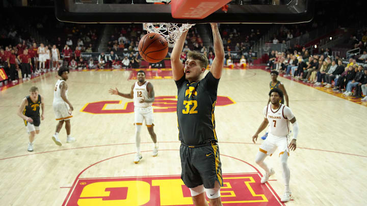 Jan 14, 2025; Los Angeles, California, USA; Iowa Hawkeyes forward Owen Freeman (32) dunks the ball against the Southern California Trojans in the second half at the Galen Center. Mandatory Credit: Kirby Lee-Imagn Images