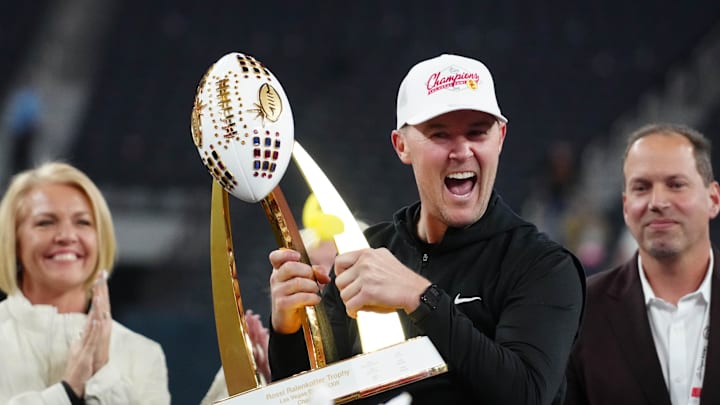 Dec 27, 2024; Las Vegas, NV, USA; Southern California Trojans head coach Lincoln Riley holds the championship trophy after the game against the Texas A&M Aggies at Allegiant Stadium. Mandatory Credit: Kirby Lee-Imagn Images