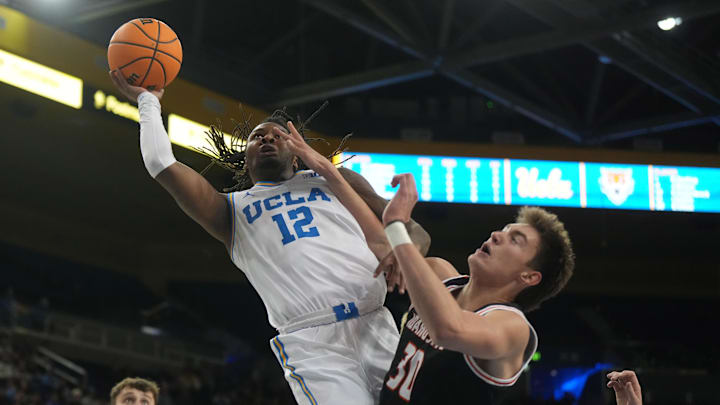 Nov 20, 2024; Los Angeles, California, USA; UCLA Bruins guard Sebastian Mack (12) shoots the ball against Idaho State Bengals forward Evan Otten (30) in the second half at Pauley Pavilion presented by Wescom. Mandatory Credit: Kirby Lee-Imagn Images Nov 20, 2024; Los Angeles, California, USA; UCLA Bruins guard Sebastian Mack (12) shoots the ball against Idaho State Bengals forward Evan Otten (30) in the second half at Pauley Pavilion presented by Wescom. Mandatory Credit: Kirby Lee-Imagn Images