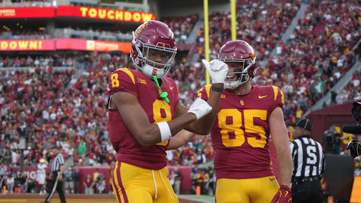 Nov 30, 2024; Los Angeles, California, USA; Southern California Trojans wide receiver Ja'Kobi Lane (8) celebrates with tight end Walker Lyons (85) after scoring on a 6-yard touchdown reception against the Notre Dame Fighting Irish in the second half at United Airlines Field at Los Angeles Memorial Coliseum. Mandatory Credit: Kirby Lee-Imagn Images