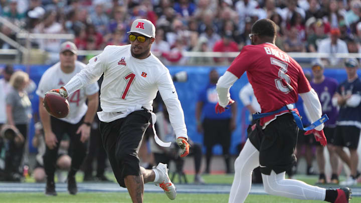 Feb 2, 2025; Orlando, FL, USA; AFC wide receiver Ja'Marr Chase of the Cincinnatti Bengals (1) carries the ball against NFC strong safety Budda Baker of the Arizona Cardinals (3)during the 2025 Pro Bowl Games at Camping World Stadium. Mandatory Credit: Kirby Lee-Imagn Images