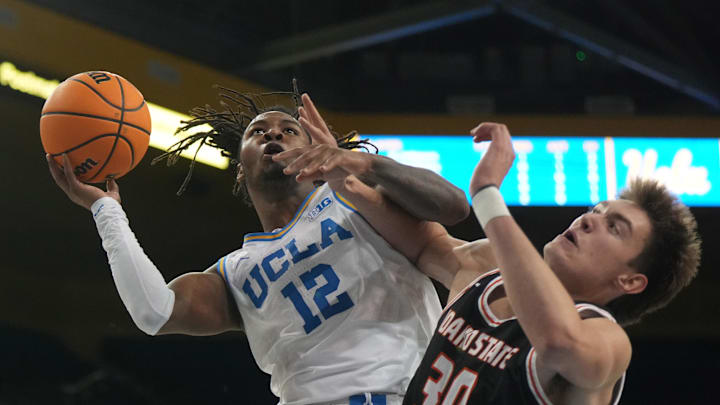 Nov 20, 2024; Los Angeles, California, USA; UCLA Bruins guard Sebastian Mack (12) shoots the ball against Idaho State Bengals forward Evan Otten (30) in the second half at Pauley Pavilion presented by Wescom. Mandatory Credit: Kirby Lee-Imagn Images