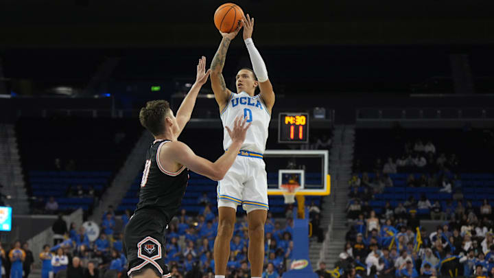 Nov 20, 2024; Los Angeles, California, USA; UCLA Bruins guard Kobe Johnson (0) shoots the ball against Idaho State Bengals forward Connor Hollenbeck (10) in the second half at Pauley Pavilion presented by Wescom. Mandatory Credit: Kirby Lee-Imagn Images