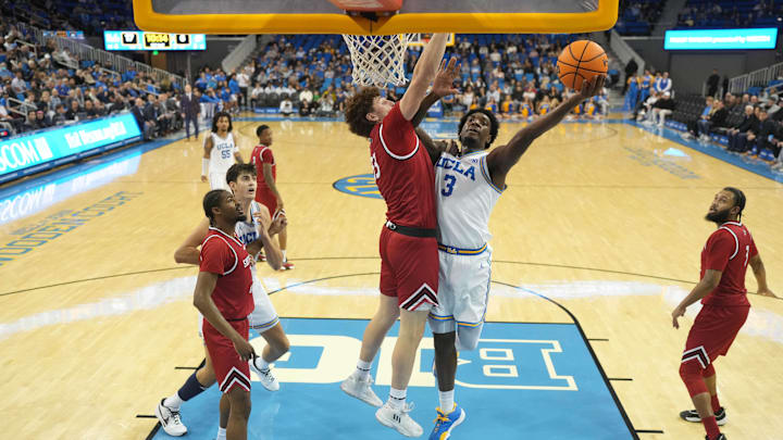 Nov 26, 2024; Los Angeles, California, USA; UCLA Bruins guard Eric Dailey Jr. (3) shoots against Southern Utah Thunderbirds forward Brock Felder (33) in the first half at Pauley Pavilion presented by Wescom. Mandatory Credit: Kirby Lee-Imagn Images Nov 26, 2024; Los Angeles, California, USA; UCLA Bruins guard Eric Dailey Jr. (3) shoots against Southern Utah Thunderbirds forward Brock Felder (33) in the first half at Pauley Pavilion presented by Wescom. Mandatory Credit: Kirby Lee-Imagn Images