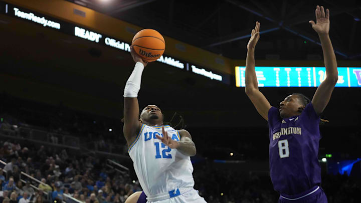 Dec 3, 2024; Los Angeles, California, USA; UCLA Bruins guard Sebastian Mack (12) shoots the ball against Washington Huskies guard Tyler Harris (8) in the second half at Pauley Pavilion presented by Wescom. Mandatory Credit: Kirby Lee-Imagn Images