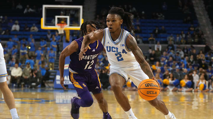 Dec 17, 2024; Los Angeles, California, USA; UCLA Bruins guard Dylan Andrews (2) dribbles the ball against Prairie View A&M Panthers guard Orlando Horton Jr. (12) in the second half at Pauley Pavilion presented by Wescom. Mandatory Credit: Kirby Lee-Imagn Images
