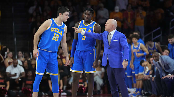 Jan 27, 2025; Los Angeles, California, USA; UCLA Bruins head coach Mick Cronin talks with guard Lazar Stefanovic (10) and guard Eric Dailey Jr. (3) against the Southern California Trojans at the Galen Center. Mandatory Credit: Kirby Lee-Imagn Images