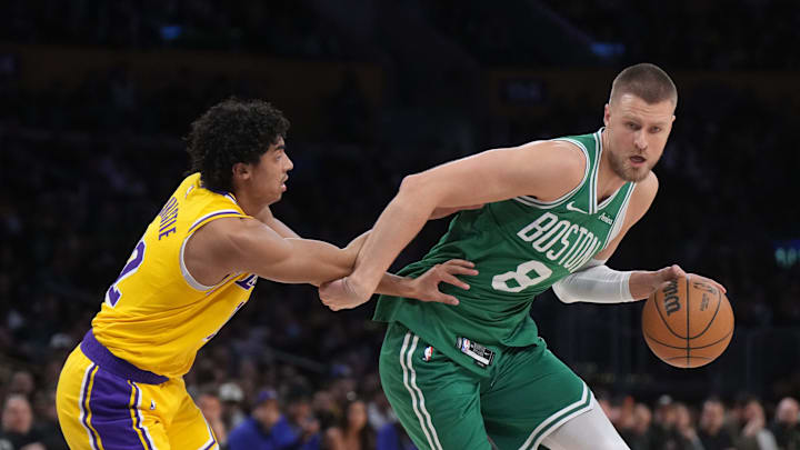 Jan 23, 2025; Los Angeles, California, USA; Boston Celtics center Kristaps Porzingis (8) dribbles the ball against Los Angeles Lakers guard Max Christie (12) in the first half at Crypto.com Arena. Mandatory Credit: Kirby Lee-Imagn Images Jan 23, 2025; Los Angeles, California, USA; Boston Celtics center Kristaps Porzingis (8) dribbles the ball against Los Angeles Lakers guard Max Christie (12) in the first half at Crypto.com Arena. Mandatory Credit: Kirby Lee-Imagn Images