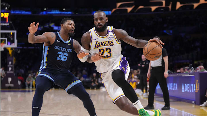 Dec 15, 2024; Los Angeles, California, USA; Los Angeles Lakers forward LeBron James (23) dribbles the ball against Memphis Grizzlies guard Marcus Smart (36) at Crypto.com Arena. Mandatory Credit: Kirby Lee-Imagn Images