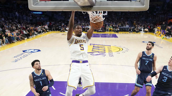 Dec 15, 2024; Los Angeles, California, USA; Los Angeles Lakers forward Cam Reddish (5) dunks the ball in the first half against the Memphis Grizzlies at Crypto.com Arena. Mandatory Credit: Kirby Lee-Imagn Images