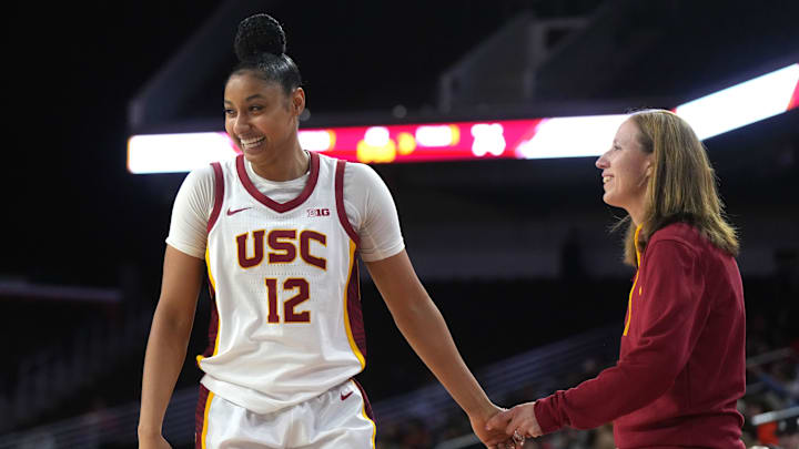 Dec 10, 2024; Los Angeles, California, USA; Southern California Trojans guard JuJu Watkins (12) celebrates with head coach Lindsay Gottlieb in the fourth quarter against the Fresno State Bulldogs at Galen Center. USC defeated Fresno State 89-40. Mandatory Credit: Kirby Lee-Imagn Images