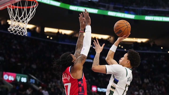 Jan 25, 2025; Inglewood, California, USA; Milwaukee Bucks guard Ryan Rollins (13) shoots the ball against LA Clippers guard Kevin Porter Jr. (77) in the second half at Intuit Dome. Mandatory Credit: Kirby Lee-Imagn Images