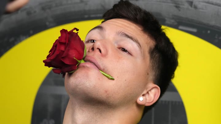 Dec 30, 2024; Los Angeles, CA, USA; Oregon Ducks quarterback Dillon Gabriel (8) poses with a rose during Rose Bowl media day at Sheraton Grand LA. Mandatory Credit: Kirby Lee-Imagn Images