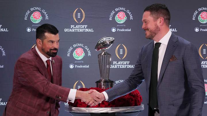 Dec 31, 2024; Los Angeles, California, USA; Ohio State Buckeyes head coach Ryan Day (left) and Oregon Ducks head coach Dan Lanning shake hands with the Leishman Trophy as a backdrop during the Rose Bowl head coaches press conference at Sheraton Grand LA. Mandatory Credit: Kirby Lee-Imagn Images Dec 31, 2024; Los Angeles, California, USA; Ohio State Buckeyes head coach Ryan Day (left) and Oregon Ducks head coach Dan Lanning shake hands with the Leishman Trophy as a backdrop during the Rose Bowl head coaches press conference at Sheraton Grand LA. Mandatory Credit: Kirby Lee-Imagn Images