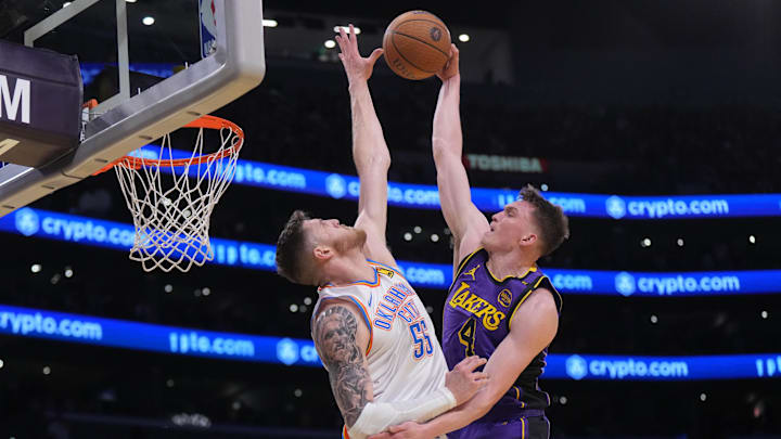 Nov 29, 2024; Los Angeles, California, USA; Los Angeles Lakers guard Dalton Knecht (4) shoots against Oklahoma City Thunder center Isaiah Hartenstein (55) in the first half  at Crypto.com Arena. Mandatory Credit: Kirby Lee-Imagn Images