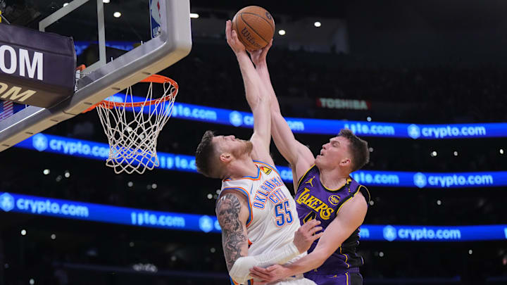 Nov 29, 2024; Los Angeles, California, USA; Los Angeles Lakers guard Dalton Knecht (4) shoots against Oklahoma City Thunder center Isaiah Hartenstein (55) in the first half at Crypto.com Arena. Mandatory Credit: Kirby Lee-Imagn Images Nov 29, 2024; Los Angeles, California, USA; Los Angeles Lakers guard Dalton Knecht (4) shoots against Oklahoma City Thunder center Isaiah Hartenstein (55) in the first half at Crypto.com Arena. Mandatory Credit: Kirby Lee-Imagn Images