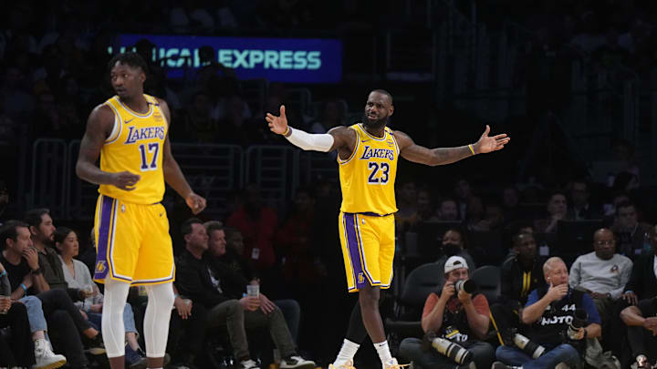 Jan 23, 2025; Los Angeles, California, USA; Los Angeles Lakers forward LeBron James (23) and forward Dorian Finney-Smith (17) react against the Boston Celtics in the first half at Crypto.com Arena. Mandatory Credit: Kirby Lee-Imagn Images