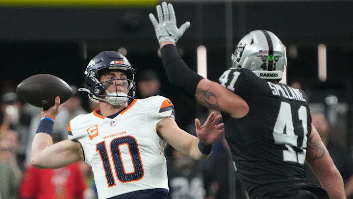 Nov 24, 2024; Paradise, Nevada, USA; Denver Broncos quarterback Bo Nix (10) throws the ball against Las Vegas Raiders linebacker Robert Spillane (41) in the first quarter at Allegiant Stadium. Mandatory Credit: Kirby Lee-Imagn Images