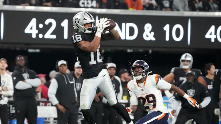 Nov 24, 2024; Paradise, Nevada, USA; Las Vegas Raiders wide receiver Jakobi Meyers (16) catches the ball against Denver Broncos cornerback Ja'Quan McMillian (29) in the fourth quarter at Allegiant Stadium. Mandatory Credit: Kirby Lee-Imagn Images