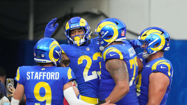 Dec 8, 2024; Inglewood, California, USA; Los Angeles Rams running back Kyren Williams (23) celebrates with quarterback Matthew Stafford (9) and offensive tackle Alaric Jackson (77) after scoring in a 7-yard touchdown run against the Buffalo Bills in the third quarter at SoFi Stadium. Mandatory Credit: Kirby Lee-Imagn Images