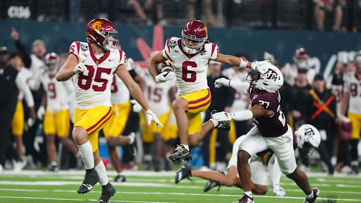 Dec 27, 2024; Las Vegas, NV, USA; Southern California Trojans wide receiver Makai Lemon (6) carries the ball against Texas A&M Aggies linebacker Daymion Sanford (27) in the second half at Allegiant Stadium. Mandatory Credit: Kirby Lee-Imagn Images Dec 27, 2024; Las Vegas, NV, USA; Southern California Trojans wide receiver Makai Lemon (6) carries the ball against Texas A&M Aggies linebacker Daymion Sanford (27) in the second half at Allegiant Stadium. Mandatory Credit: Kirby Lee-Imagn Images