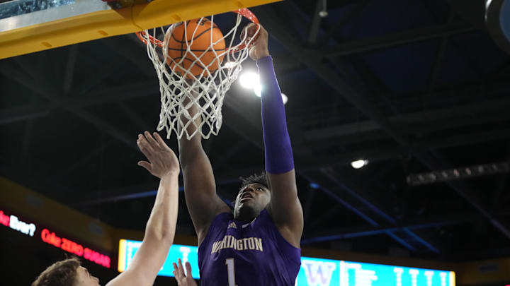 Dec 3, 2024; Los Angeles, California, USA; Washington Huskies forward Great Osobor (1) dunks the ball against UCLA Bruins forward Tyler Bilodeau (34) in the first half at Pauley Pavilion presented by Wescom. Mandatory Credit: Kirby Lee-Imagn Images