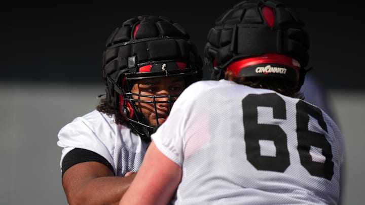 Cincinnati Bearcats offensive lineman John Williams competes in drills against offensive lineman Landon Fickell during spring football practice, Monday, March 4, 2024, at Nippert Stadium in Cincinnati.