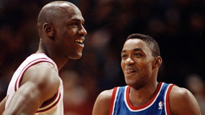 Chicago Bulls' Michael Jordan, left, and Isiah Thomas of the Detroit Pistons smile as they talk while waiting for the lights to brighten at Chicago Stadium before their game, Jan. 24, 1992.