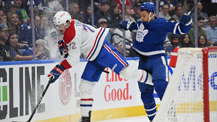 Sep 26, 2024; Toronto, Ontario, CAN;  Montreal Canadiens defenseman Arber Xhekaj (72) and Toronto Maple Leafs forward Ryan Reaves (75) battle for the puck in the first period at Scotiabank Arena. Mandatory Credit: Dan Hamilton-Imagn Images