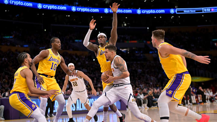 Mar 19, 2025; Los Angeles, California, USA; Los Angeles Lakers center Christian Koloko (10), guard Gabe Vincent (7), forward Jarred Vanderbilt (2) and guard Luka Doncic (77) defend a drive by Denver Nuggets forward Michael Porter Jr. (1) in the second half at Crypto.com Arena. Mandatory Credit: Jayne Kamin-Oncea-Imagn Images Mar 19, 2025; Los Angeles, California, USA; Los Angeles Lakers center Christian Koloko (10), guard Gabe Vincent (7), forward Jarred Vanderbilt (2) and guard Luka Doncic (77) defend a drive by Denver Nuggets forward Michael Porter Jr. (1) in the second half at Crypto.com Arena. Mandatory Credit: Jayne Kamin-Oncea-Imagn Images
