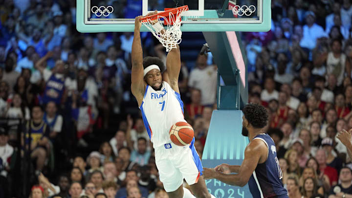Aug 10, 2024; Paris, France; France power forward Guerschon Yabusele (7) dunks against United States centre Joel Embiid (11) in the first quarter in the men's basketball gold medal game during the Paris 2024 Olympic Summer Games at Accor Arena. Mandatory Credit: Kyle Terada-Imagn Images