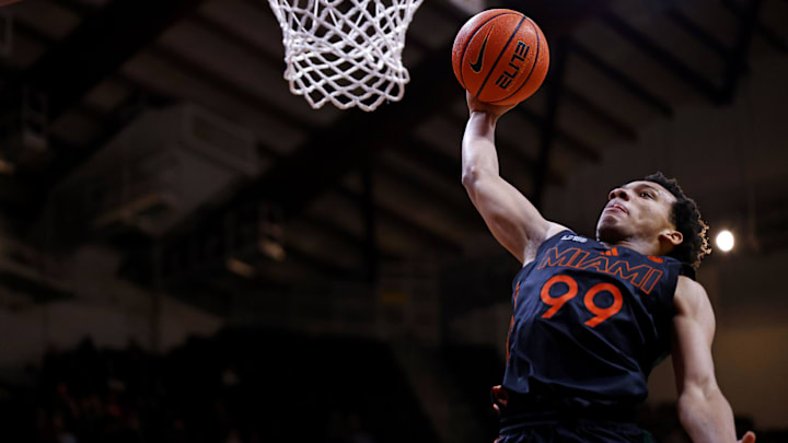 Jan 4, 2025; Blacksburg, Virginia, USA; Miami Hurricanes guard Divine Ugochukwu (99) dunks the ball during the second half against the Virginia Tech Hokies at Cassell Coliseum. Mandatory Credit: Peter Casey-Imagn Images