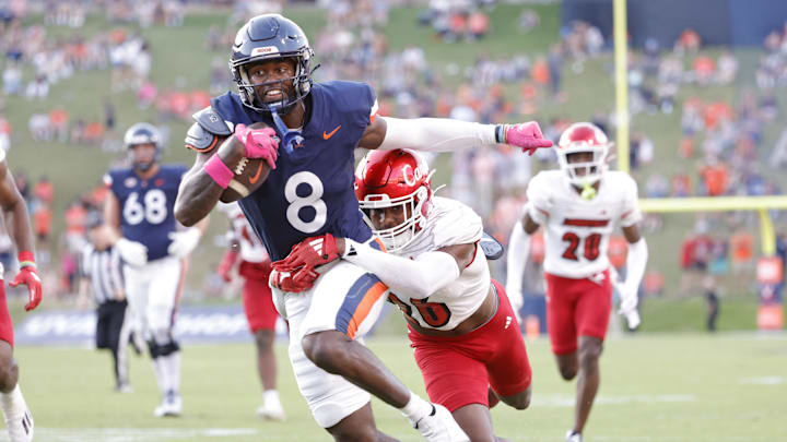 Oct 12, 2024; Charlottesville, Virginia, USA; Virginia Cavaliers wide receiver Malachi Fields (8) carries the ball as Louisville Cardinals defensive back M.J. Griffin (26) defends during the second half at Scott Stadium. Mandatory Credit: Amber Searls-Imagn Images