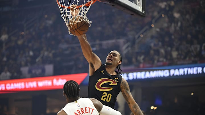 Oct 31, 2025; Cleveland, Ohio, USA; Cleveland Cavaliers forward Jaylon Tyson (20) dunks beside Toronto Raptors forward RJ Barrett (9) in the first quarter at Rocket Arena. Mandatory Credit: David Richard-Imagn Images