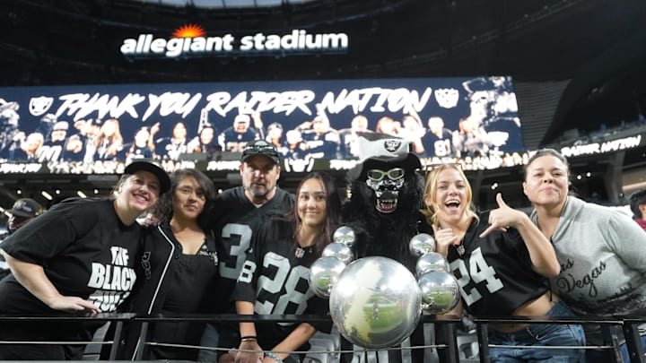 Jan 5, 2025; Paradise, Nevada, USA; Las Vegas Raiders fans (from left) Marilyn Acasio aka Jungle Jane, Maria Lopez, Geoff Skarr, Alyssa Skarr, Mark Acasio aka Gorilla Rilla, Amber Mielke and Monica Martinez pose during the game against the Los Angeles Chargers at Allegiant Stadium. Mandatory Credit: Kirby Lee-Imagn Images